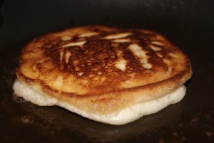 A deliciously perfect pancake, just crisping up lightly.